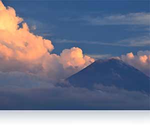 Nikon D610 photo of a mountain in the clouds showing accurate metering.