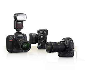 Photo of a trio of Nikon D4s cameras, one with a Speedlight flash attached, one with an Ethernet cable attached and one with the WT-5A attached