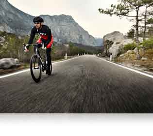 Nikon D500 DSLR photo of a bike rider on the road highlighting Nikon's processing power