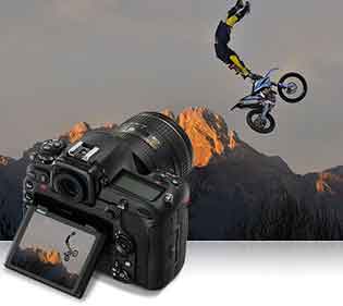 Nikon D500 DSLR photo of a stunt biker in air inset with the camera and photo on the lCD